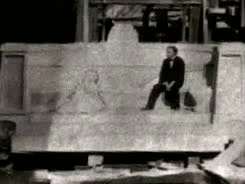 Houdini sitting on the unfinished exedra, 1916